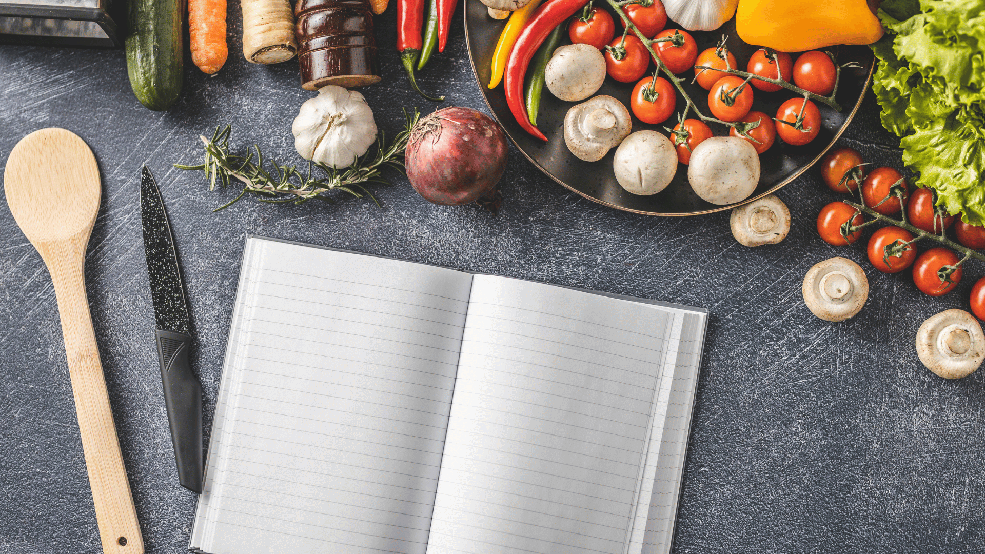 Open recipe book with blank pages surrounded by ingredients Mealmento™