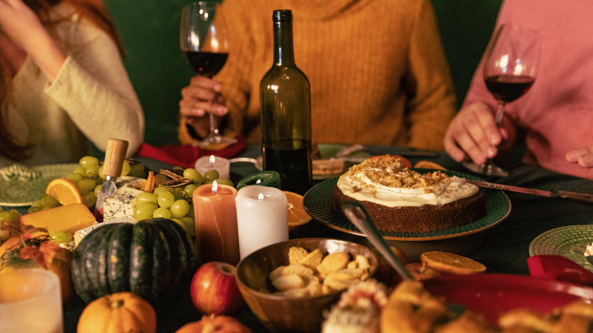 Friends gather around a table with various fall foods Mealmento