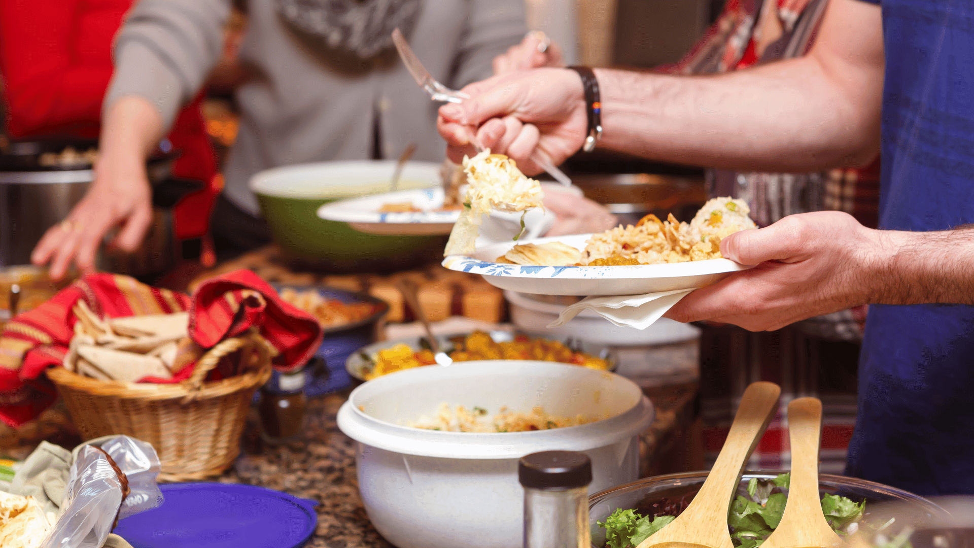 A festive game day table filled with wings, nachos, sliders, drinks, and desserts organized with Mealmento