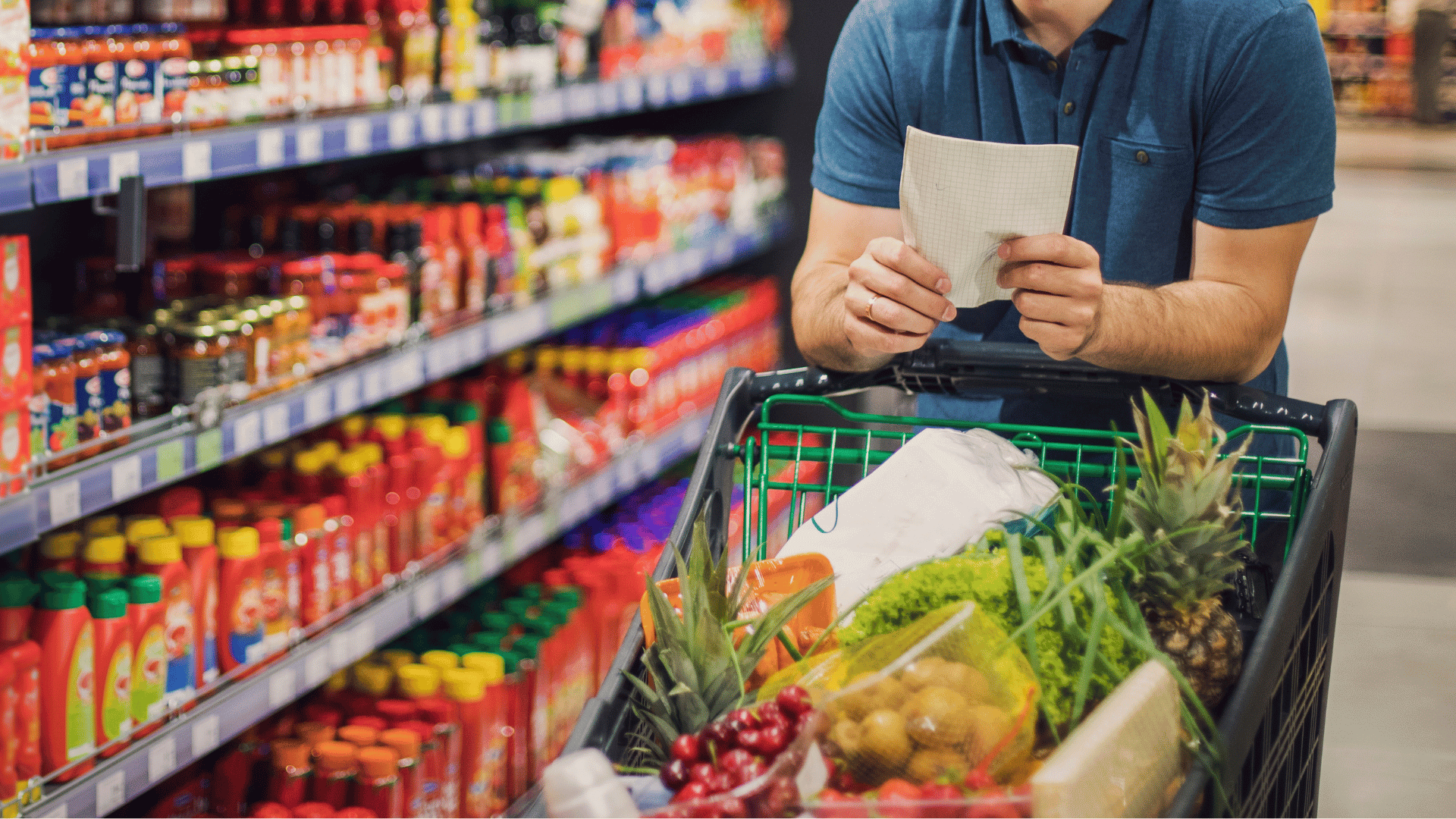 Smart grocery list on a phone next to fresh produce powered by Mealmento