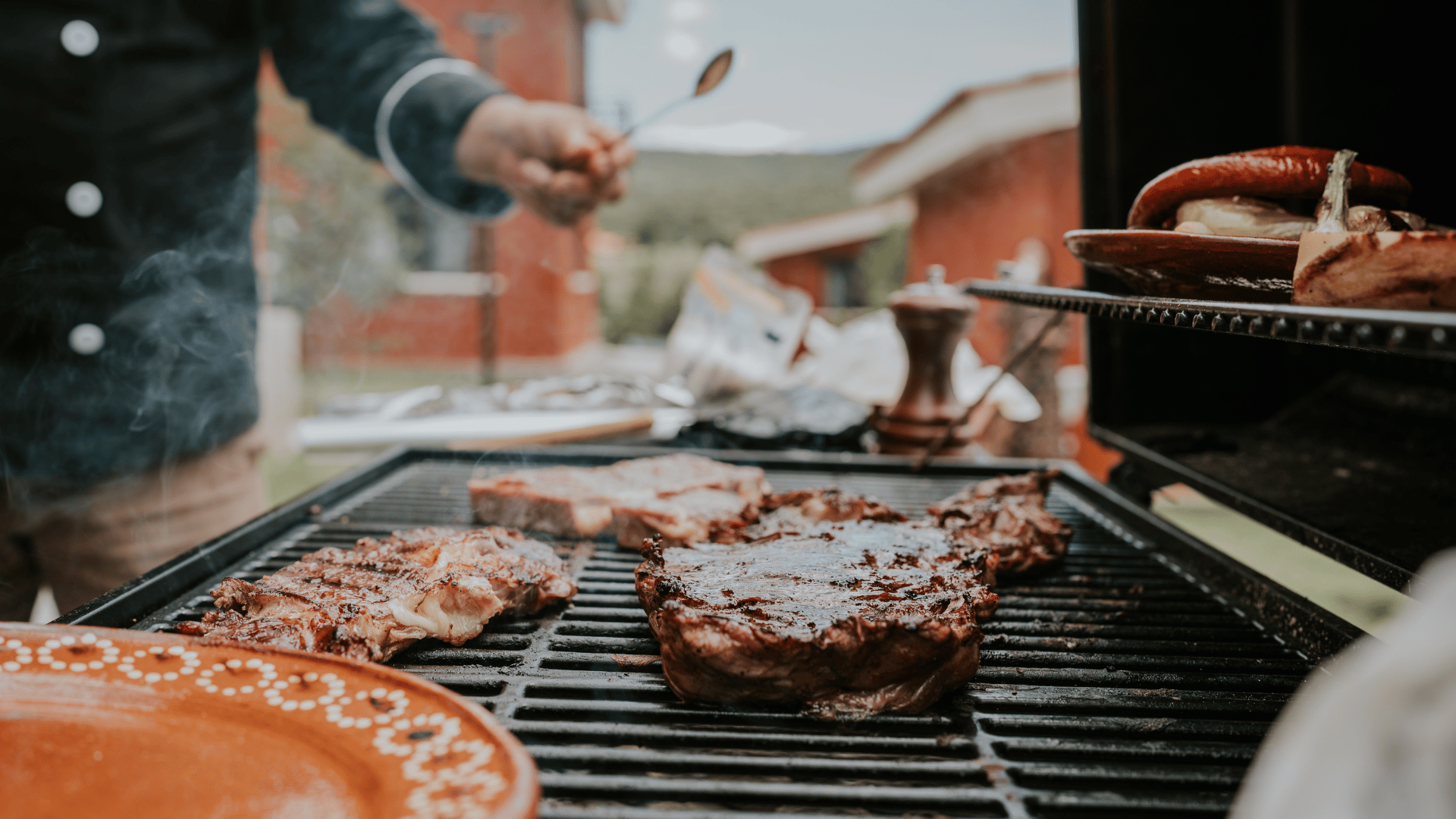 Tailgating spread with wings, sliders, nachos, and chili served outdoors with Mealmento
