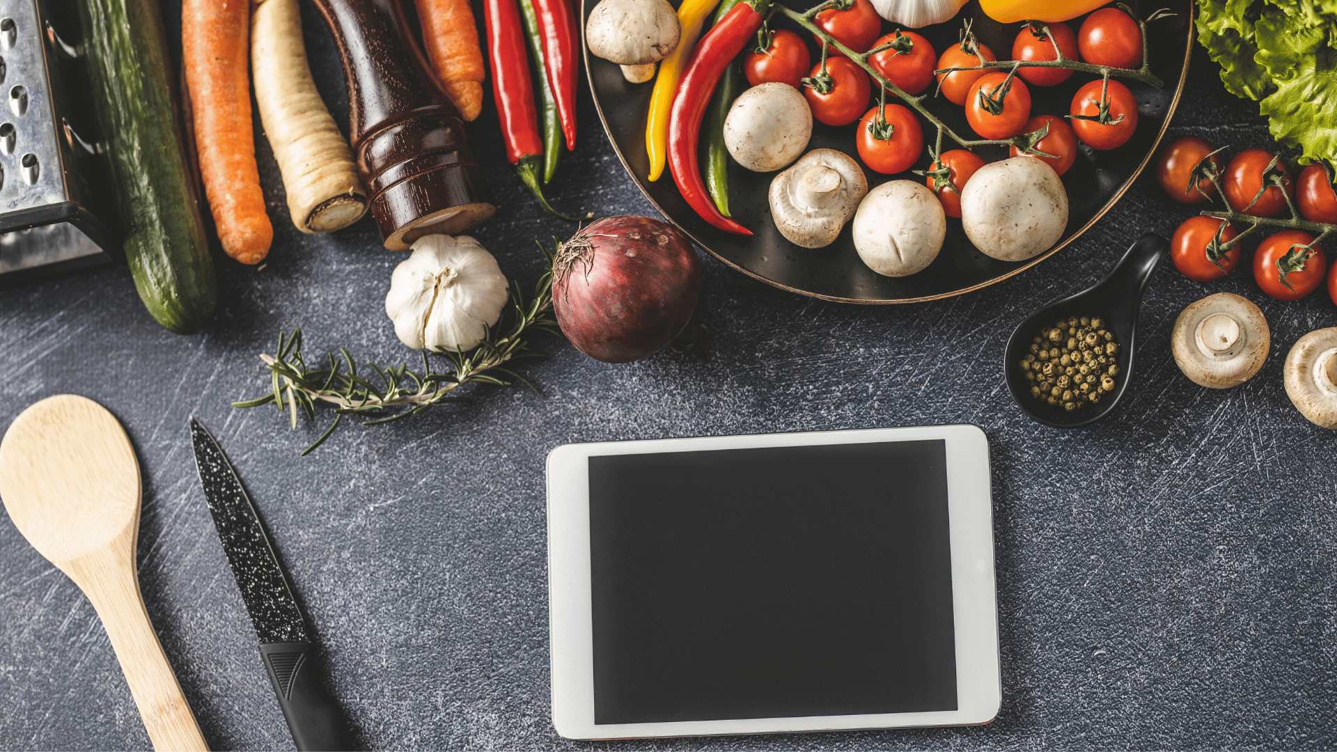 Vintage recipe cards alongside a tablet showing preserved digital heirloom recipes with Mealmento