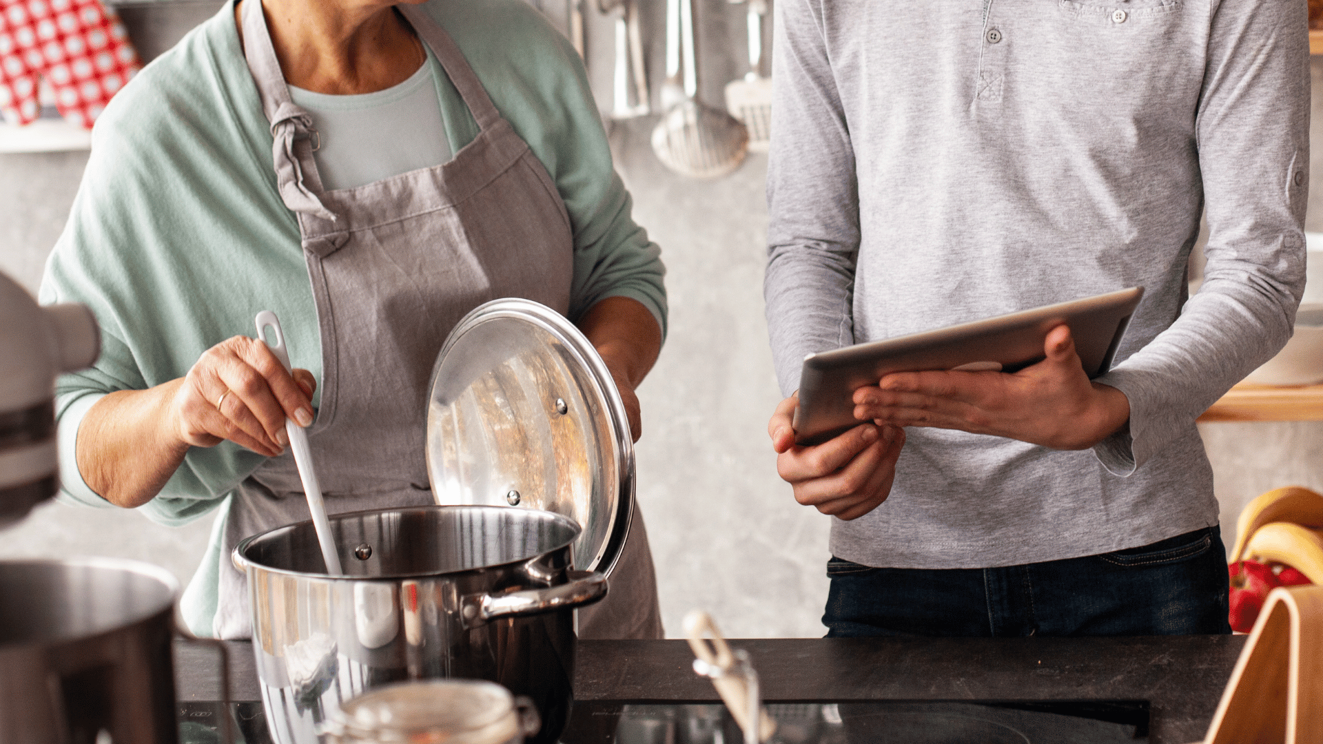Family gathered around a table sharing recipes on Mealmento